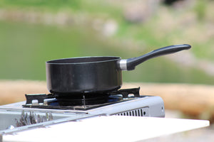 single burner stove with small pot on top